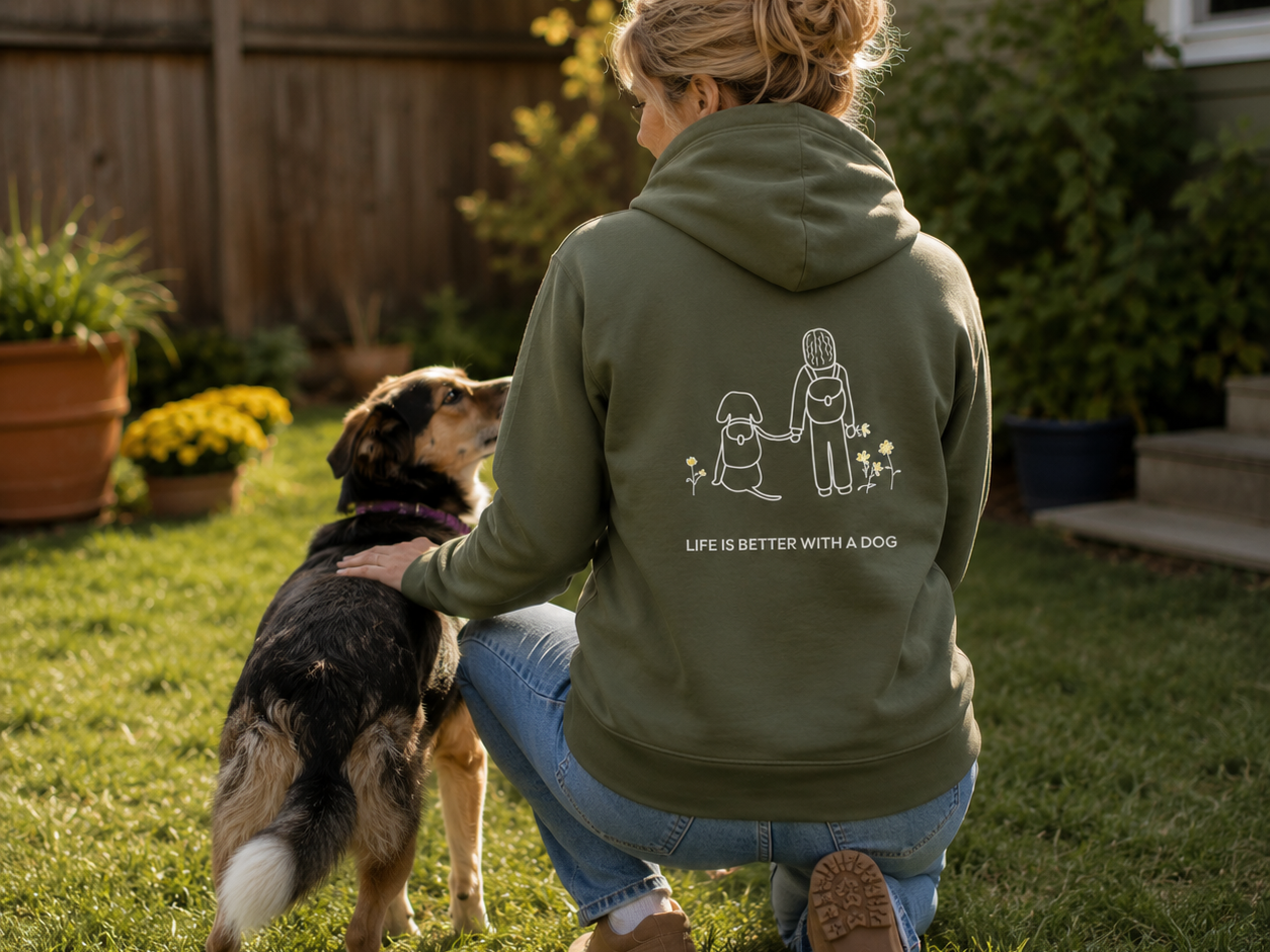 Dog Hiking hoodie featuring a person and dog hiking past wildflowers