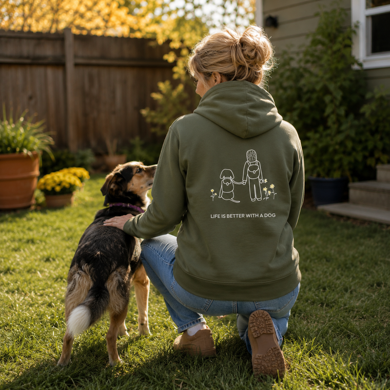 Dog Hiking hoodie featuring a person and dog hiking past wildflowers
