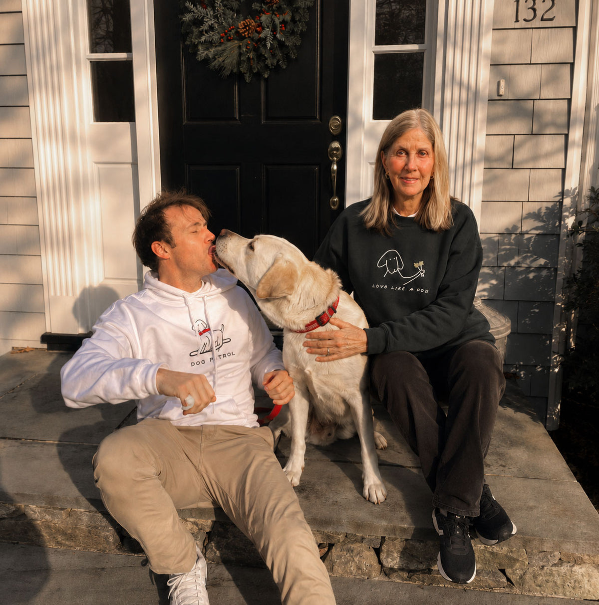 Paul and Mimi with their dog on the front steps